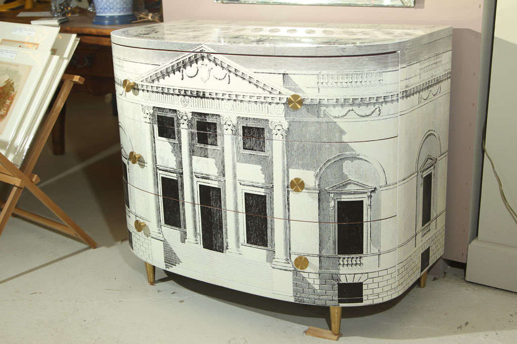 PALLADIAN INSPIRED ARCHITECTURAL DESIGN ON THIS 1950 FORNASETTI DEMI LUNE COMMODE. ONE OF A SERIES OF GREAT ITALIAN ARCHITECTURE. LITHOGRAPH LAMINATED SURFACE. THREE DRAWERS WITH MAGOGANY INTERIORS. LE TASTEFUL LITHOGRAPHIE' CONTAINED ANCIENT ROME