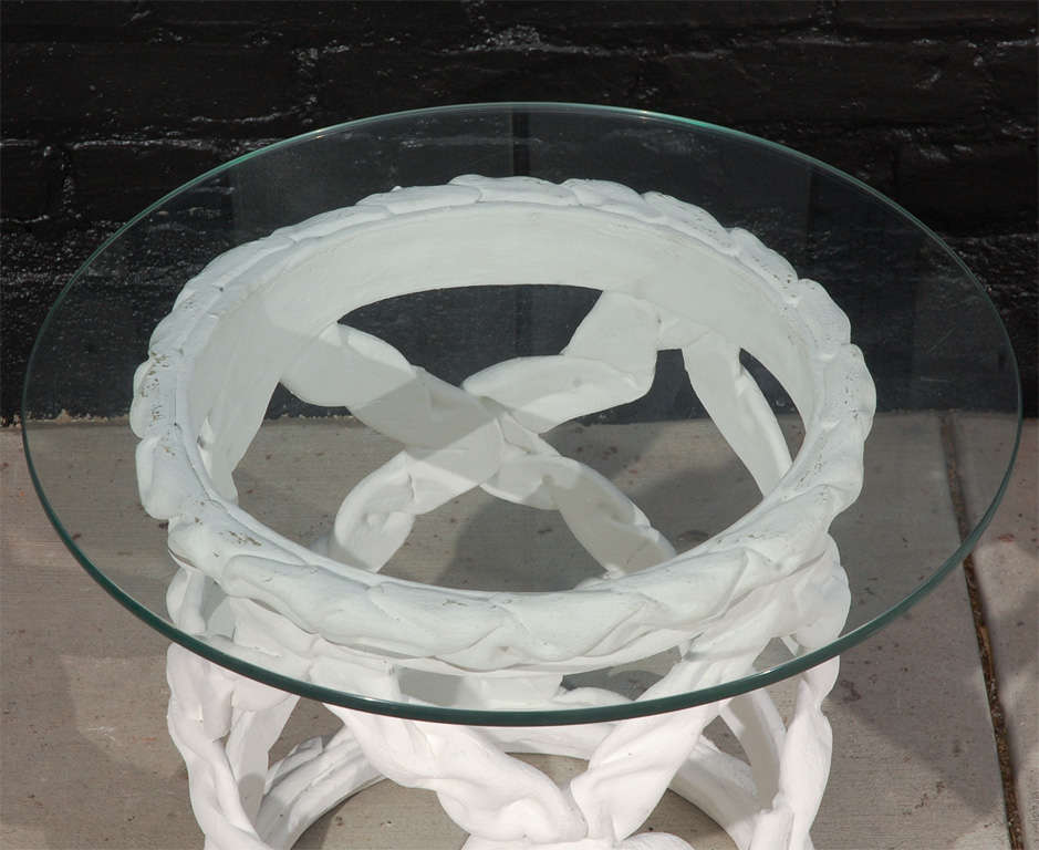 Pair of cylindrical, ribbon motif plaster side tables with round glass tops.