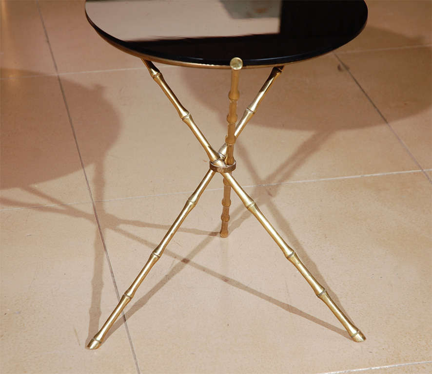 Brass, faux bamboo, gueridon side table with round black glass top.`