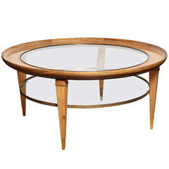 A Round Two-Tiered Rosewood Coffee Table with Glass Top