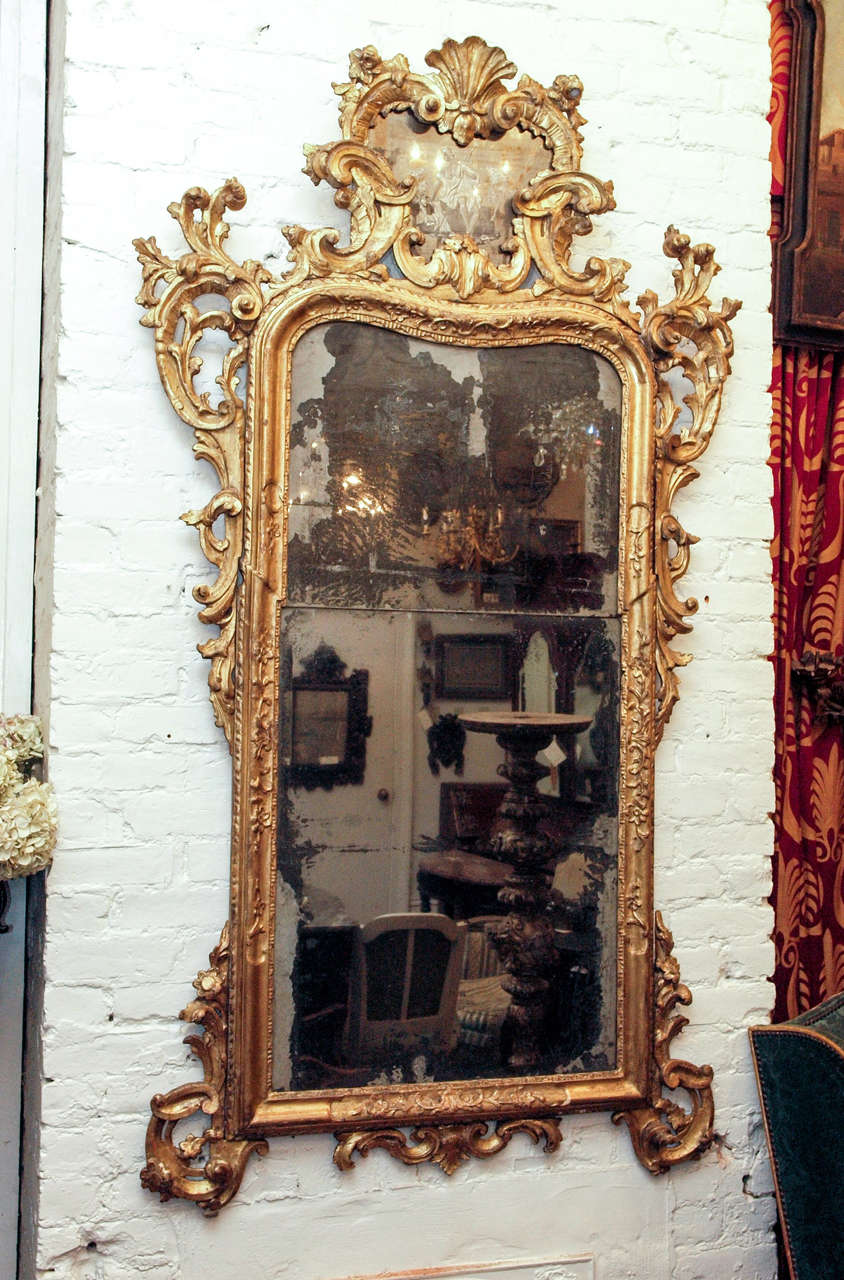 Baroque Venetian Gilt Wood Looking Glass (Mirror) with original plate, parquet backing and gilt ( with some minor restorations and losses)