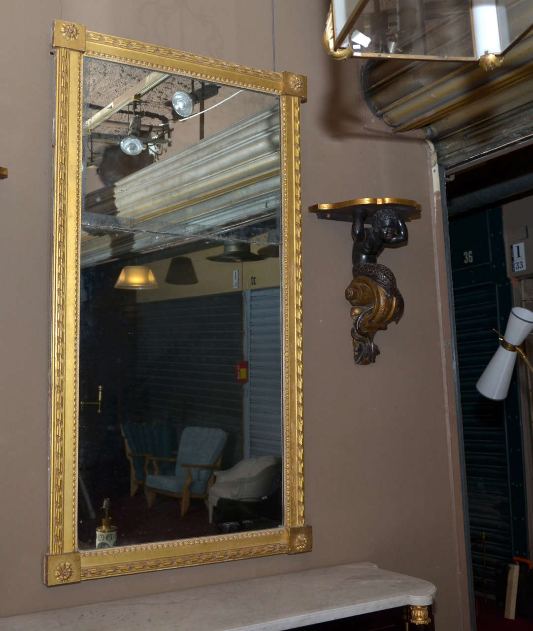 Beautiful Louis XVI period mirror. Gilded wood trumeau mirror. Pearl and ribbon frame. Flower decorated square corners. Beautiful wood back side. Original mercury mirror.

The mirror is in its original condition. Scratches and minor splints on the