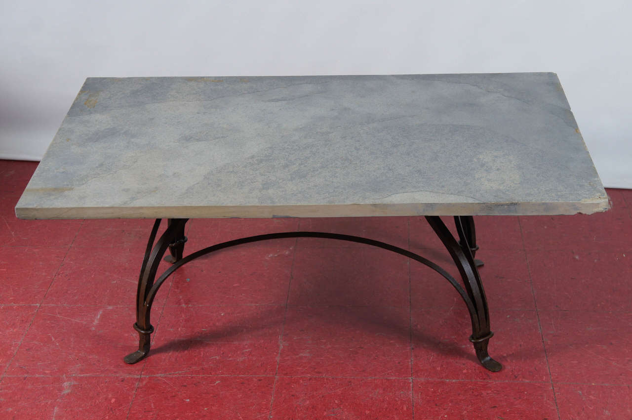 Solid elegance describes this indoor or outdoor bistro base style coffee table with its arching wrought iron metal base and gray rough surface stone top.  This table can be used indoor or outdoors.  Top and base can be sold separately.  Base alone
