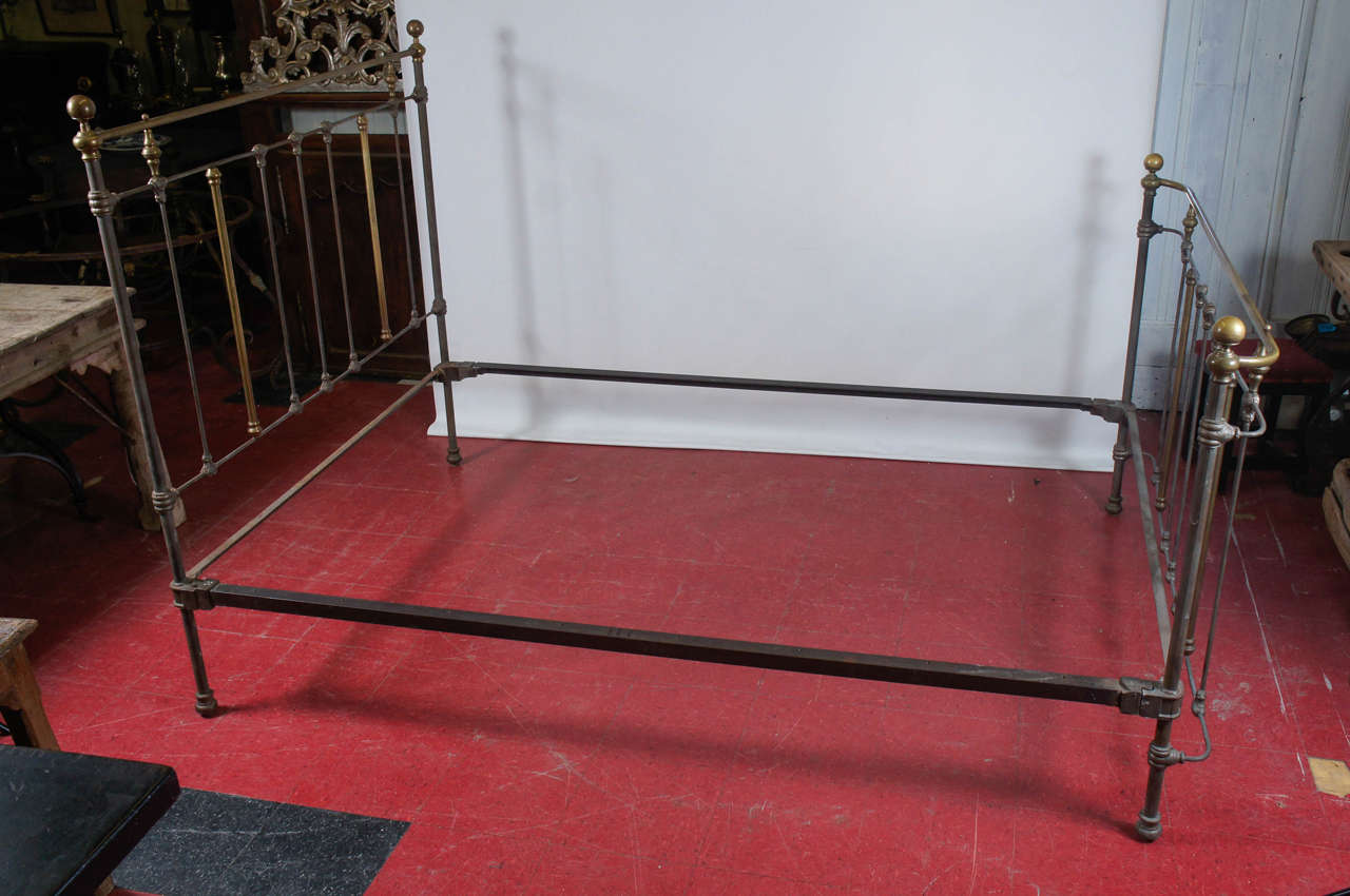 Combination brass and iron queen bed dates from the 19th century. A pair of iron side railings attach the head and foot railings or just use the headboard.  The two side rails measures 80