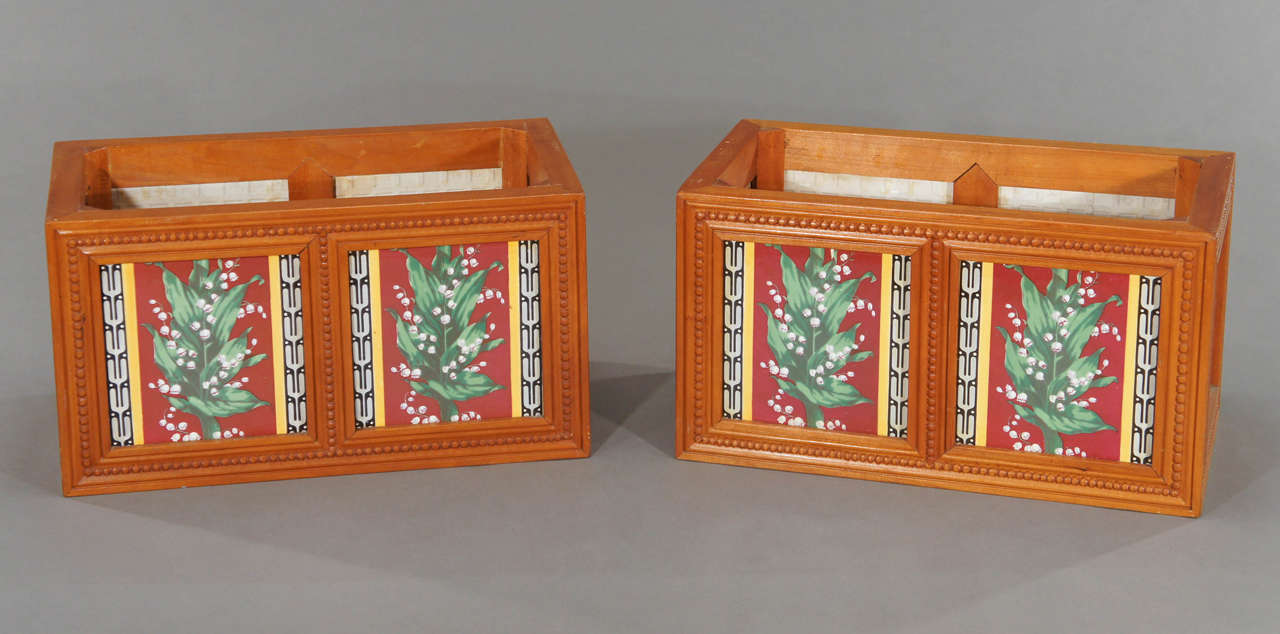 This pair of jardinieres is made of 19th century Mintons porcelain tiles which have been mounted into later constructed jardinieres. The tiles are all matching, each one decorated with lily of the valley floral motifs.
Beautifully detailed