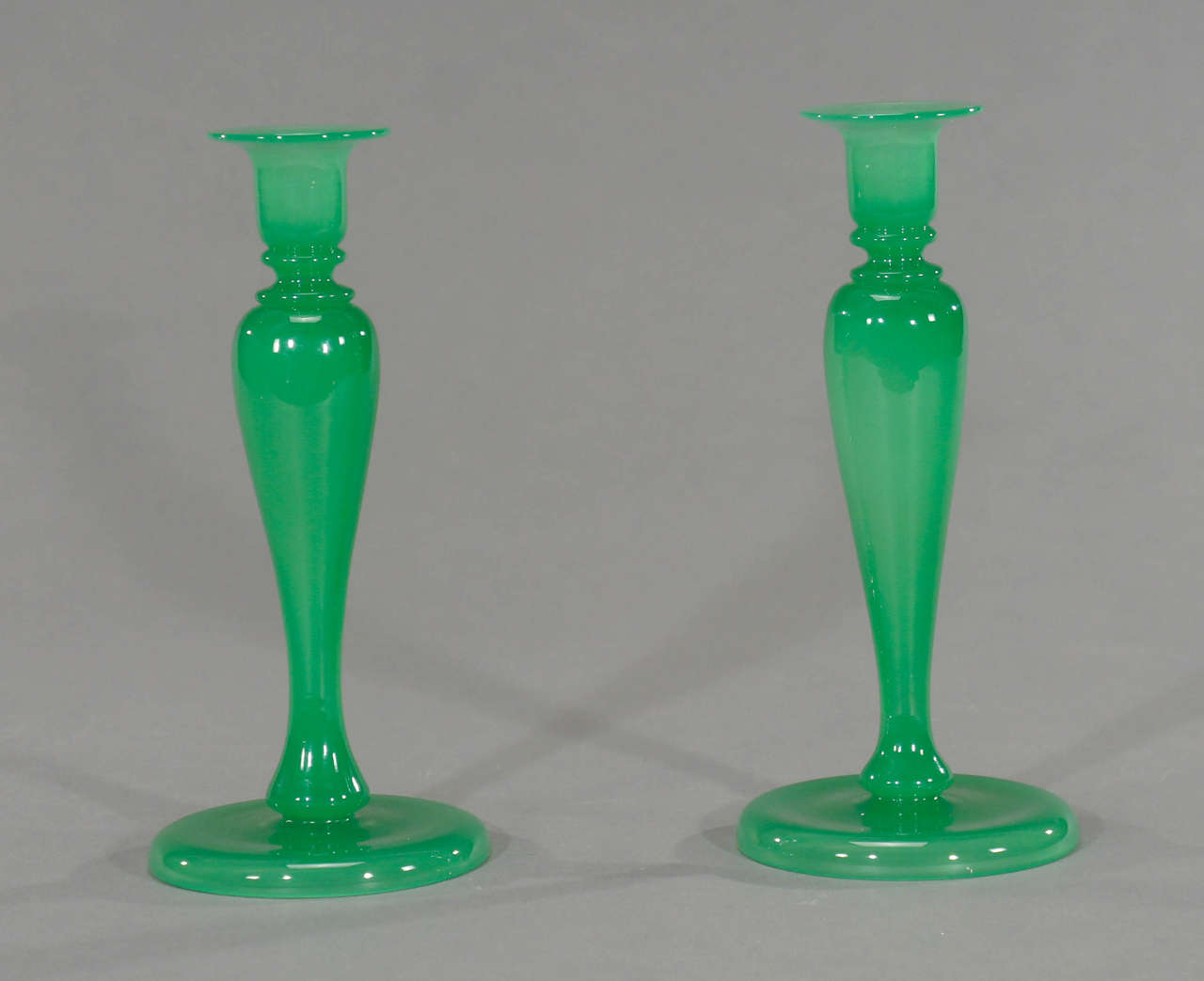 Questa meravigliosa coppia di candelieri soffiati a mano è stata realizzata da Stevens & Williams o Steuben nel periodo di transizione in cui Frederick Carder si stava trasferendo alla Corning Glass Works per diventare il nuovo direttore. Il colore