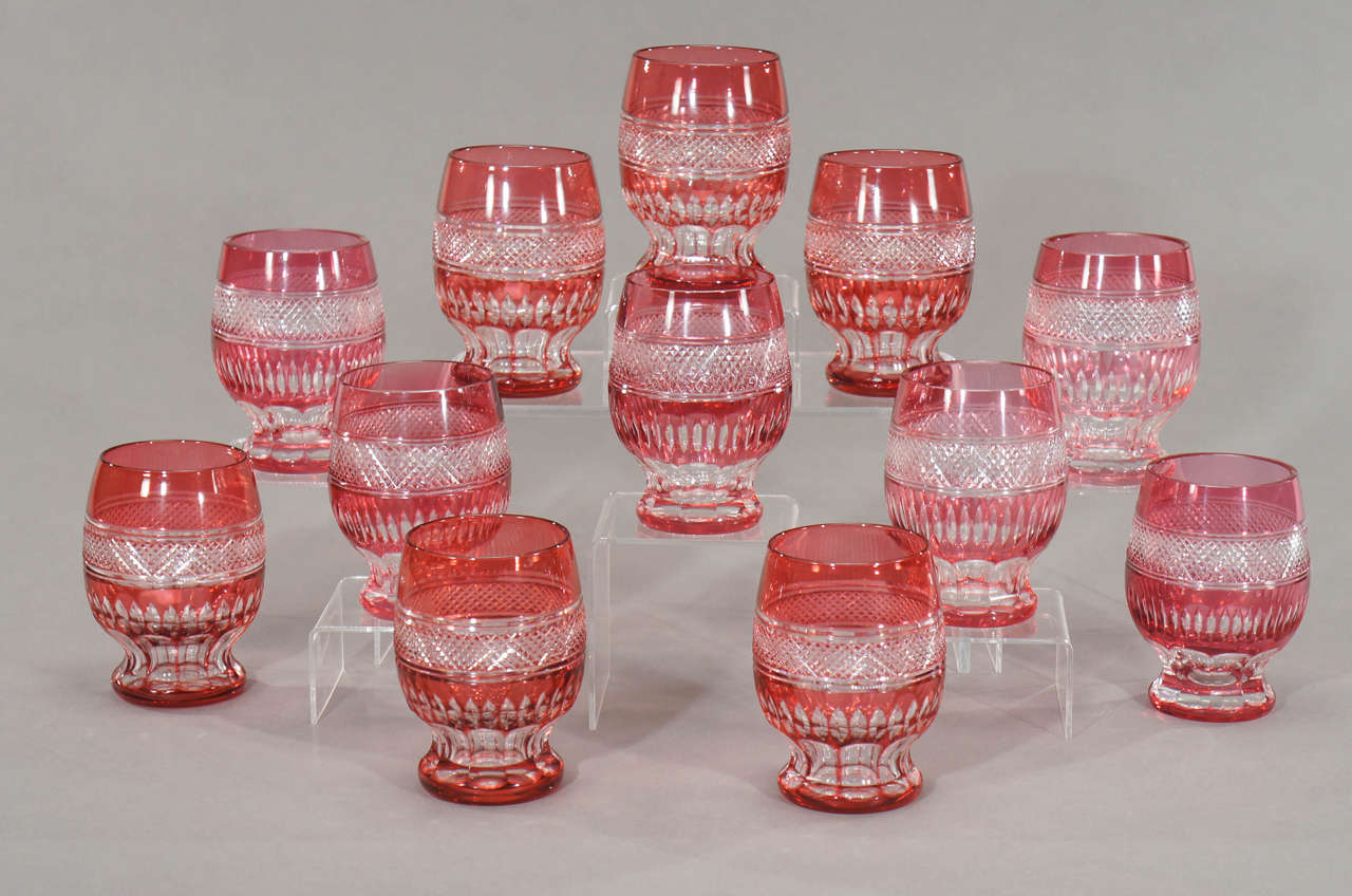 This set of tumblers are fabulous in the hand. Heavy but comfortable and elegantly shaped, they make the perfect water glass or dramatic on the back bar. They are hand blown crystal, overlaid in cranberry and cut to clear in a combination of diamond