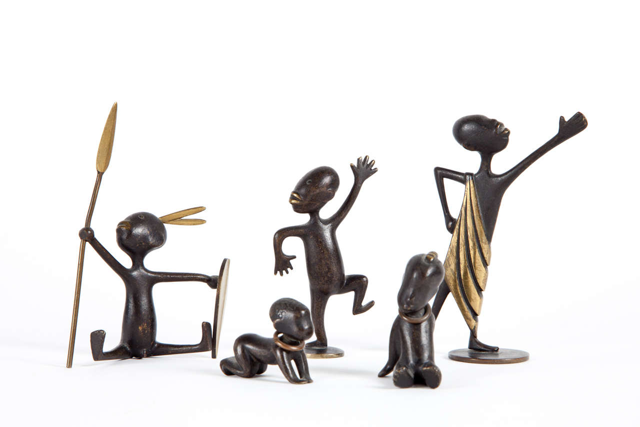 A group of five Hagenauer bronze and patinated bronze Pigmy warriors and children.
