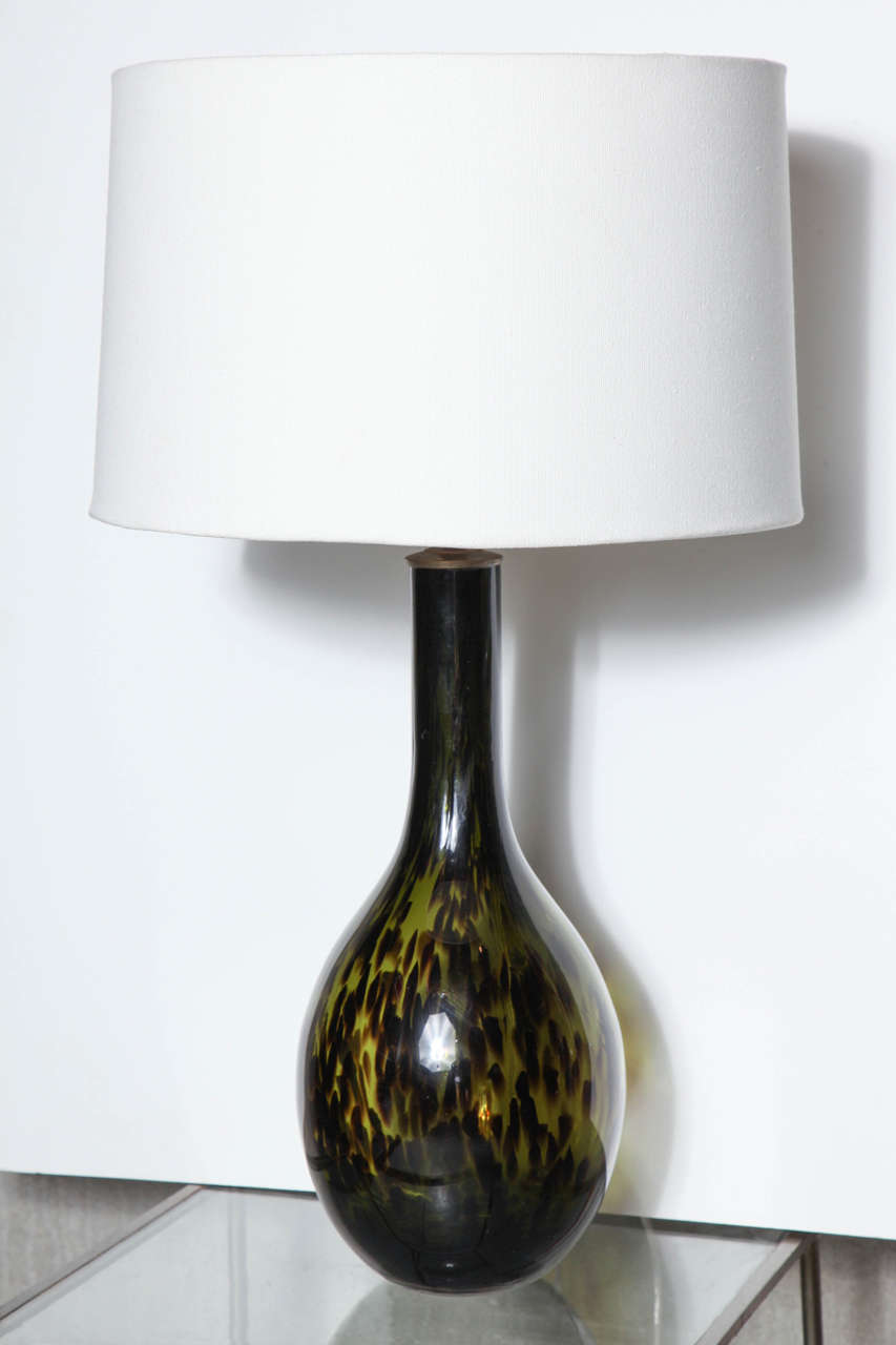 Exceptional spotted olive glass lamps. Spots fuse at the base and neck merging the exotic with a grounding effect. Base is 17