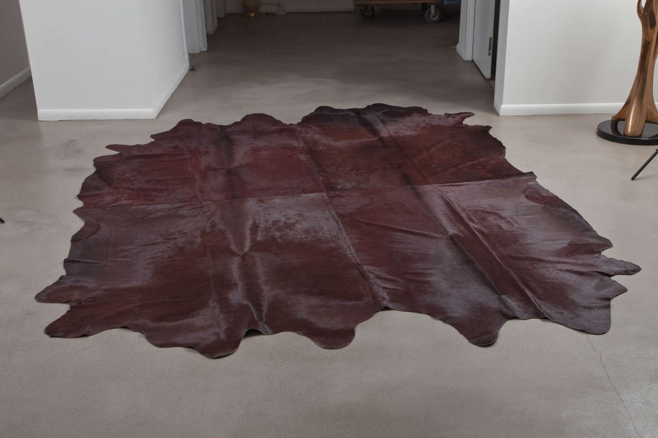 This Pure Chestnut Cowhide XL Rug is two large cowhides sewn together and dyed by Brazilian craftsman. Pure Rugs originate from the Pampas Grasslands of Brazil, all individually selected for their superior quality, shine and softness. Their premium