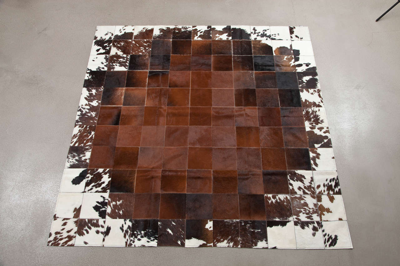 This Pure square patchwork cowhide rug is sewn together by Brazilian craftsman. Pure's cowhides originate from the Pampas Grasslands of Brazil, all individually selected for their superior quality, shine and softness. Then each patchwork rug is