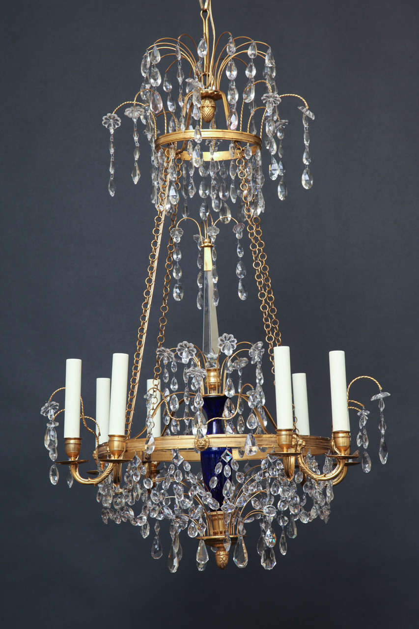 Gilt Bronze And Crystal Eight Light Chandelier With Center Cobalt Glass Urn.  The Chandelier is suspended By Four Chains With Top And Bottom Crystal Sprays.