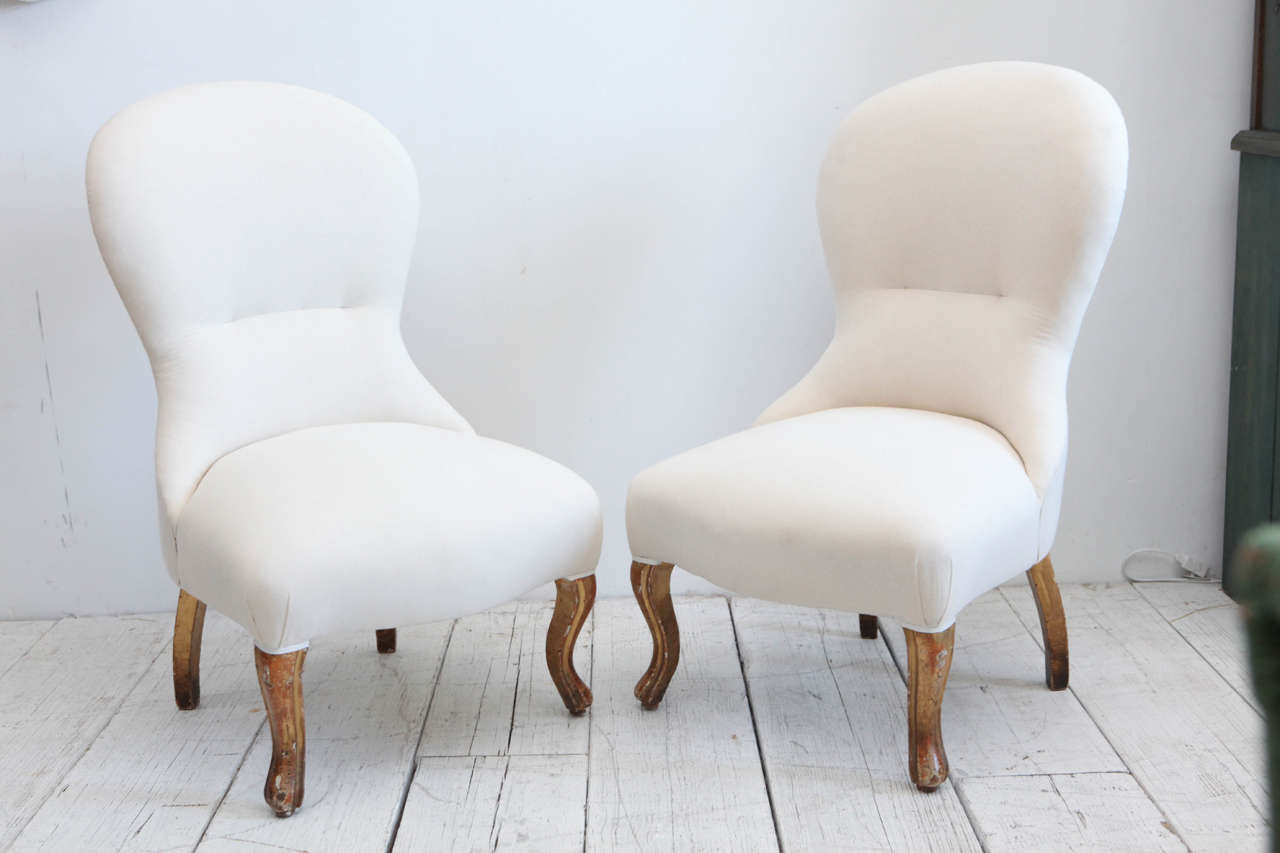 Vintage Italian chairs with gold finish legs and slight tuft in back, newly upholstered in natural muslin.