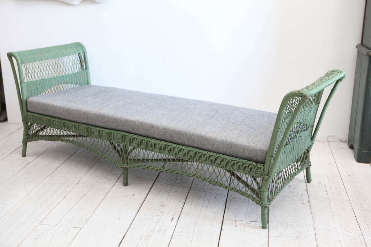 Large open daybed in original green paint. Newly upholstered in reverse denim. Suitable for indoors or covered loggia.