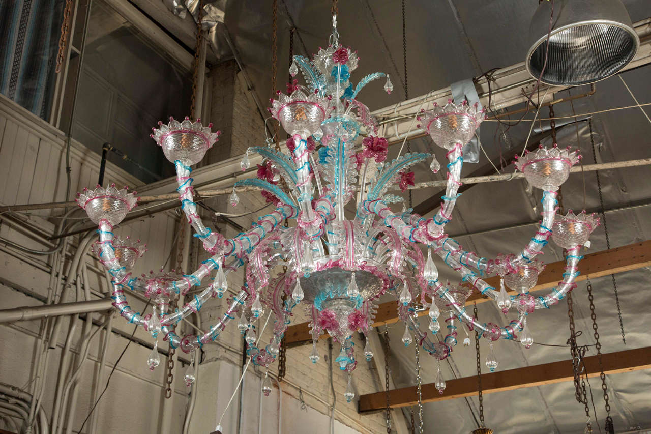 This custom-made highly decorative floral tear drop Murano glass chandelier was salvaged locally from Mt Washington, CA. Each arm is made up of dozens of tiny handblown trumpets with splashes of color at the ends. Colors are baby blue and pink. This