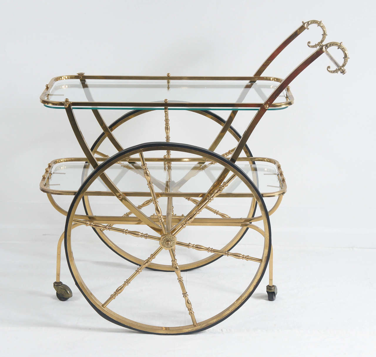 these carts are so fun.
Use for a bar, roll in tea and deserts, use as an occasional table.
Nice patina to brass. Shows age well.