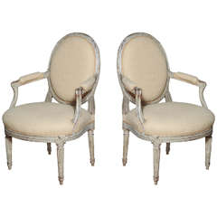 A Pair of Louis XVI Carved and Painted Beechwood Fauteuils A La Reine