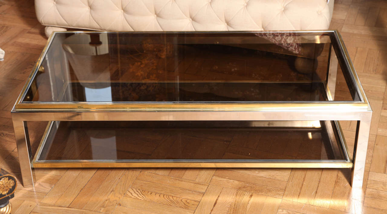 A Maison Charles Stamped Brass, Chrome and Smoked Glass Two Tier Coffee Table. France, C. 1970