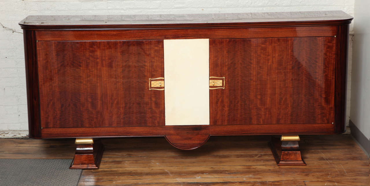 Art Deco walnut sideboard with parchment center and original bronze hardware. Two interior drawers.