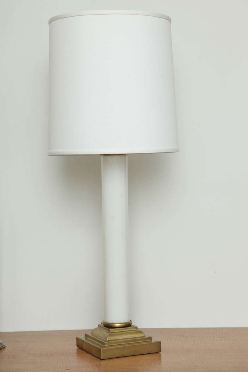 The body of the lamp is a white glossy glass cylinder with a gold brass base. The classic lamp shade is a cream silk fabric. Updated electrical cords. Lighting with one cup and one bulb for each lamp.
These fine lamps are classy and fit nicely in