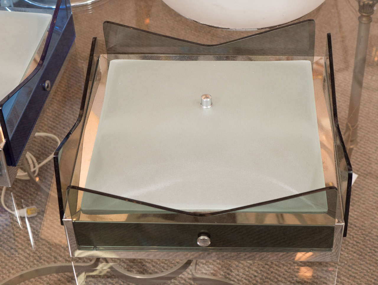 A ceiling mount light fixture in the style of Fontana Arte, circa 1970. Chrome box with four grey glass side panels that attache to the box by a single screw. Bottom of fixture is a satin finish square glass dish attached by a single central screw