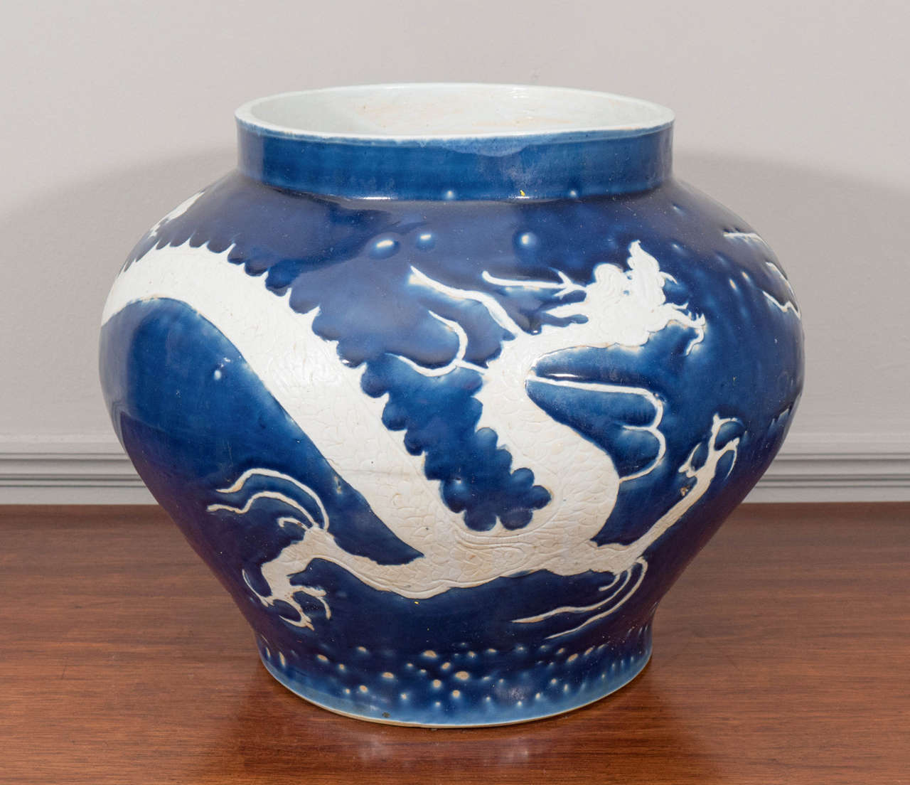 Pair of blue and white Chinese porcelain cachepots with dragon motif.