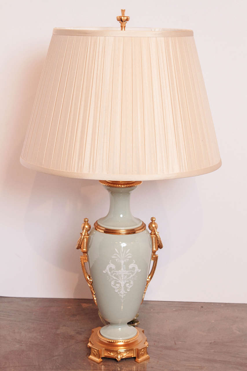 19th century French Louis XVI celadon pâte-sur-pâte porcelain urns with gilt bronze details and base custom wired into lamps