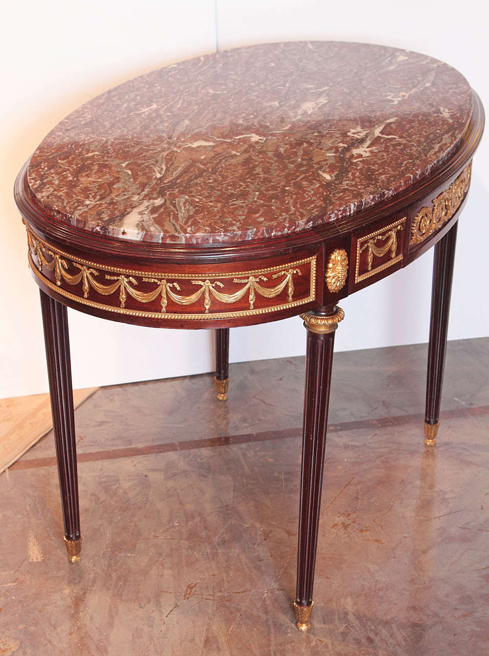 19th century French Louis XVI signed F. Linke marble-topped center table
gilt bronze swag details.