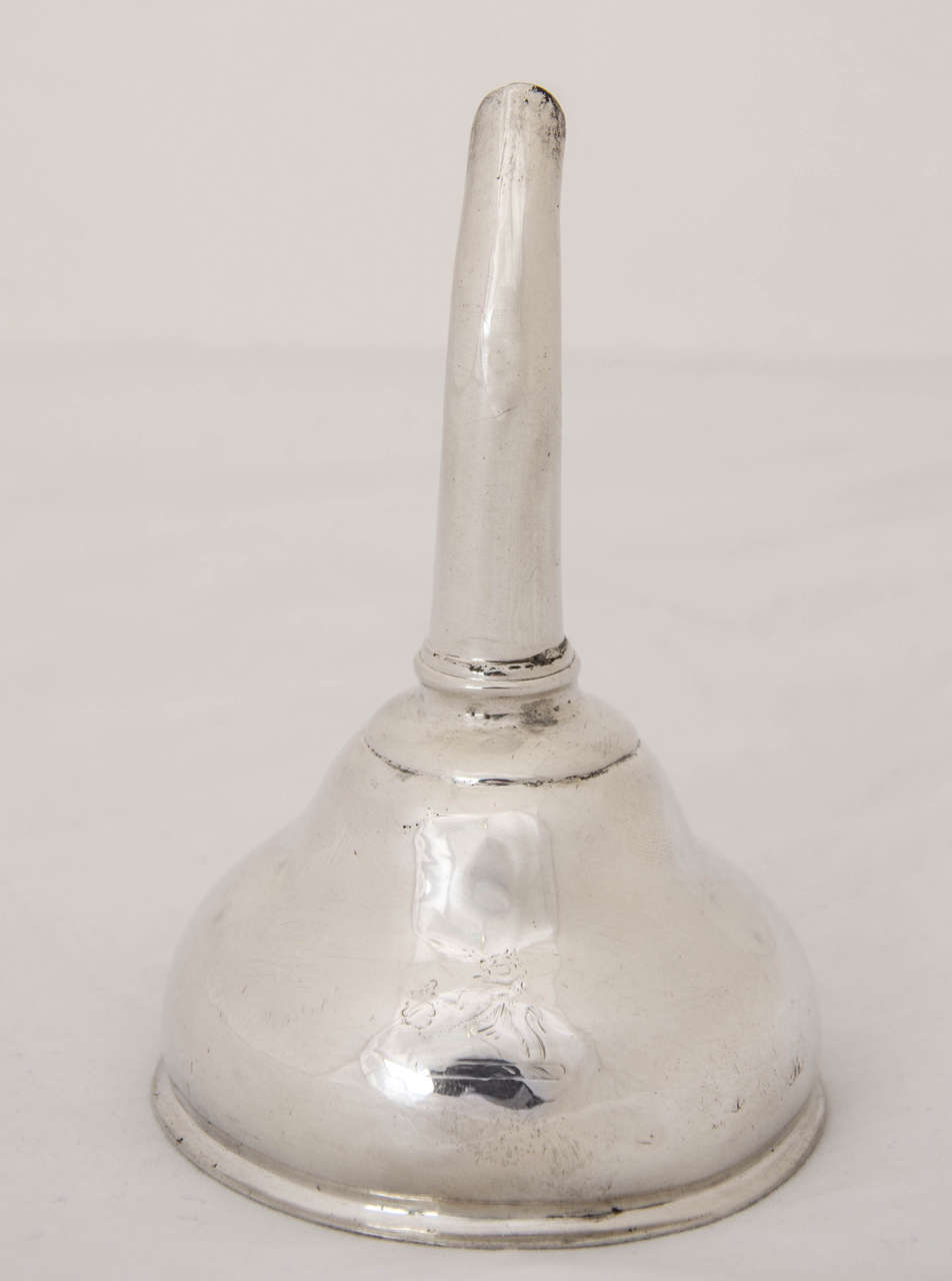 A  George III Antique Silver Irish Silver Wine Funnel, of plain circular waisted form. The body of the funnel is further embellished with a bright cut engraved crest.  Height 4inches, width 2.5 inches 6.4 cm. Depth 1.25 inches 3.2 cm Made by William
