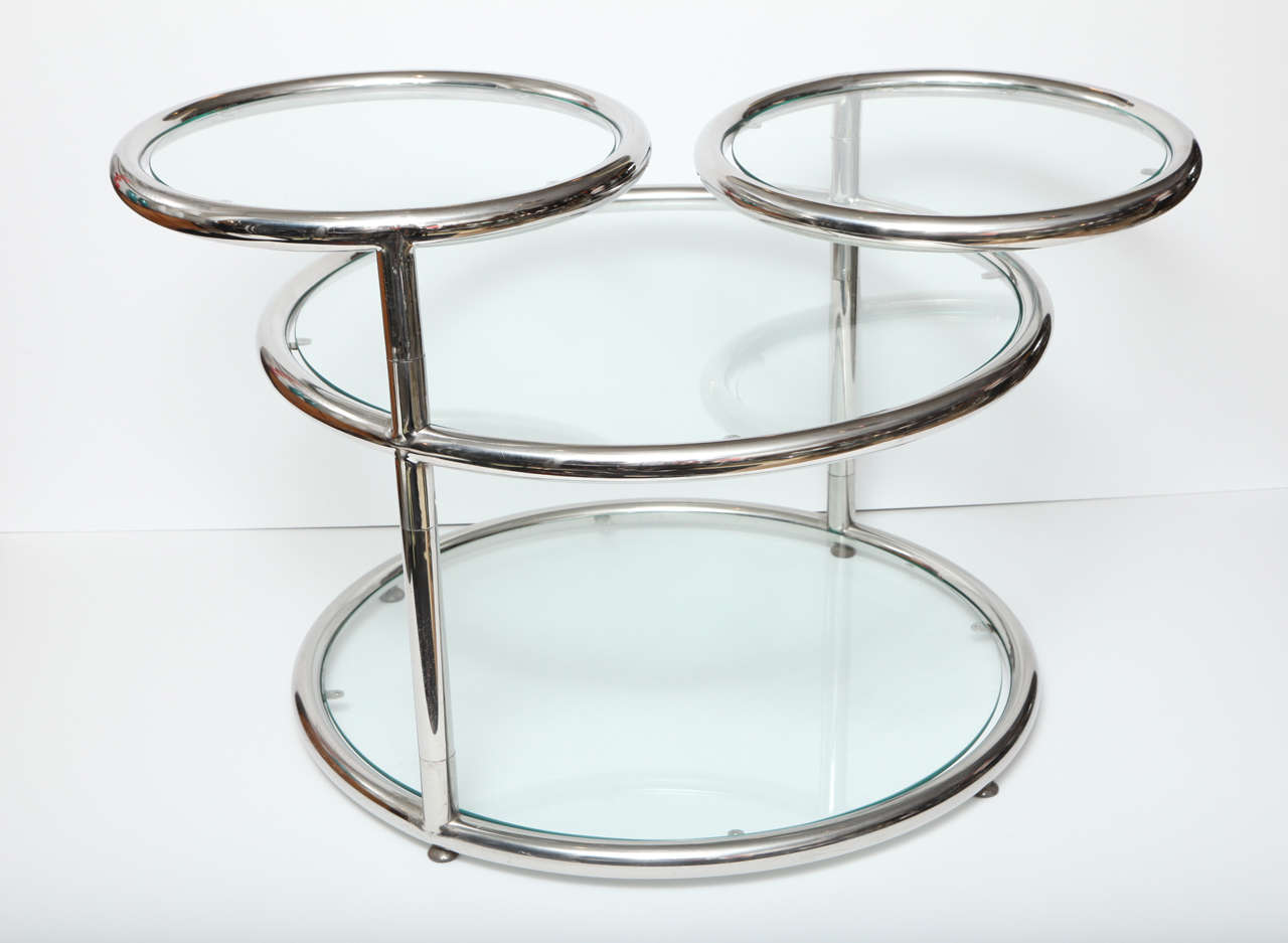 Chrome coffee table from Italy, C 1960. The table is made of tubular chrome.  The two arms swing open. It measures 64