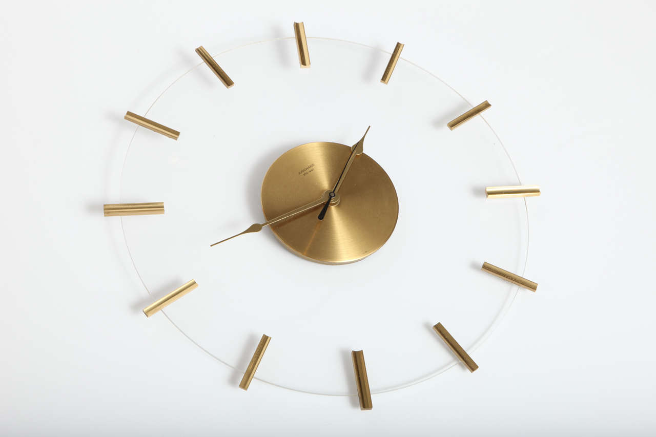 Decorative wall clock by Junghans, C 1960. Lucite with brass details. Battery operated.