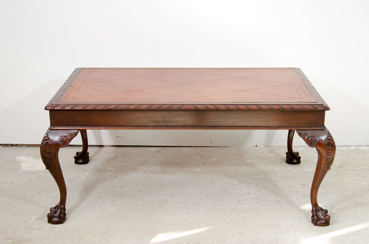 Beautiful Chippendale style hand carved mahogany coffee table with it's original leather on the top. circa 1900. it was made in Philadelphia.