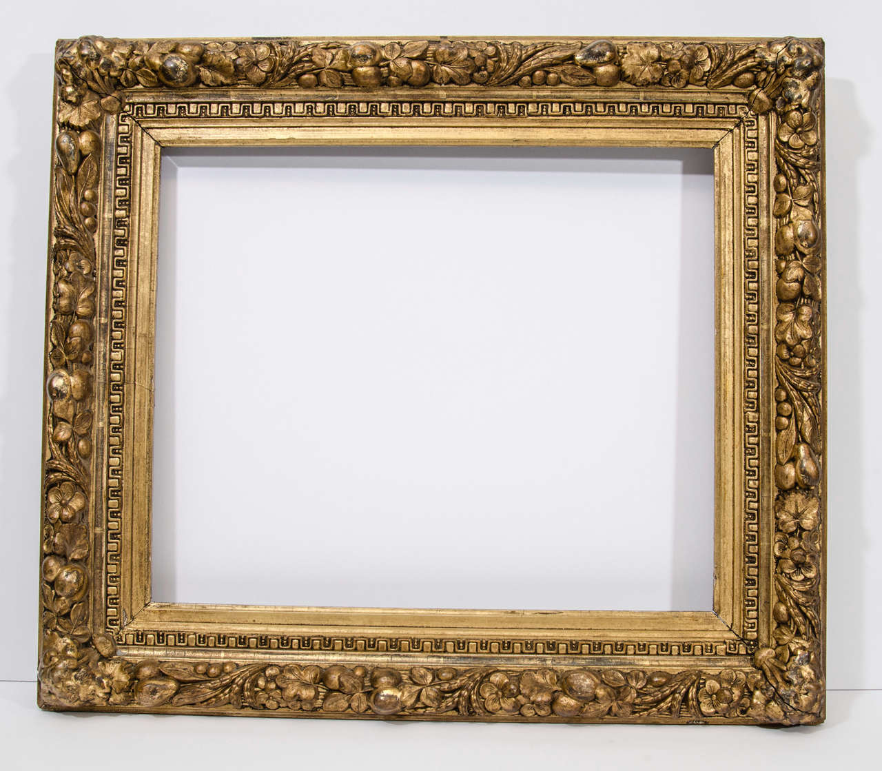 Gold leaf frame with high relief composition ornament of fruit and flowers

Exterior dimensions: 23 1/2 x 20 1/2 inches
Rabbet dimensions: 17 3/4 x 14 3/4 inches
Moulding width: 3 1/4 inches