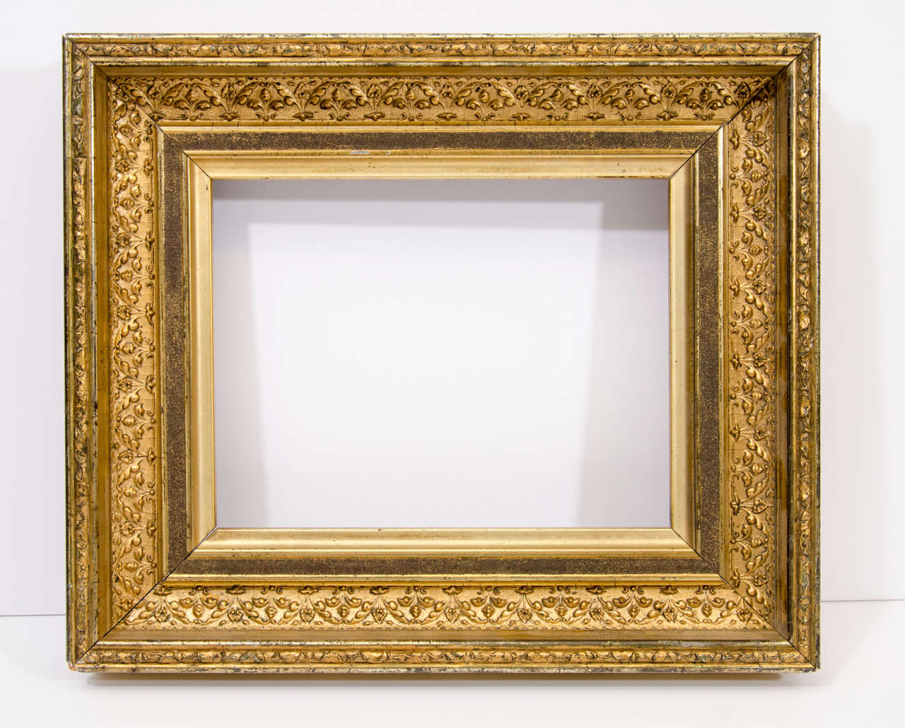 19th century lemon gold frame with composition Gothic Revival ornamentation and sanded panel

Exterior dimensions: 13 7/8 x 11 3/4 inches
Rabbet dimensions: 9 1/4 x 7 1/8 inches
Moulding width: 2 5/8 inches