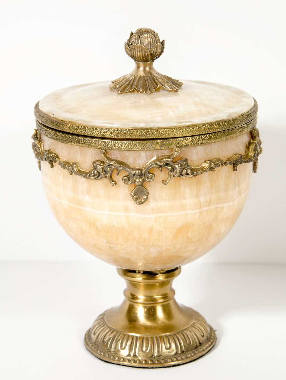 This hand carved onyx covered compote features exquisite gilt bronze detailing