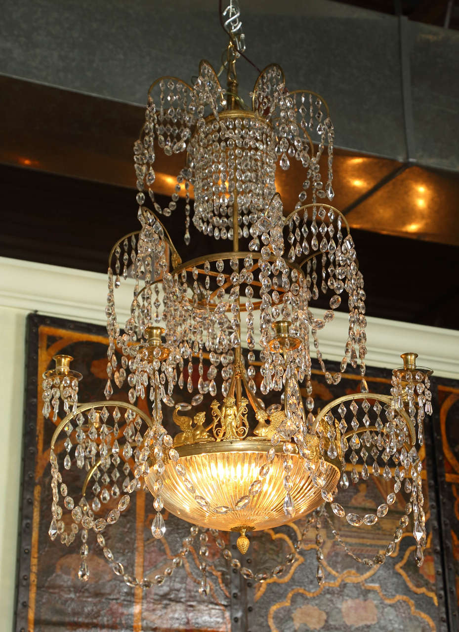 A stunning early 19th Century three tier Swedish Neoclassical dore bronze and crystal eight light chandelier.