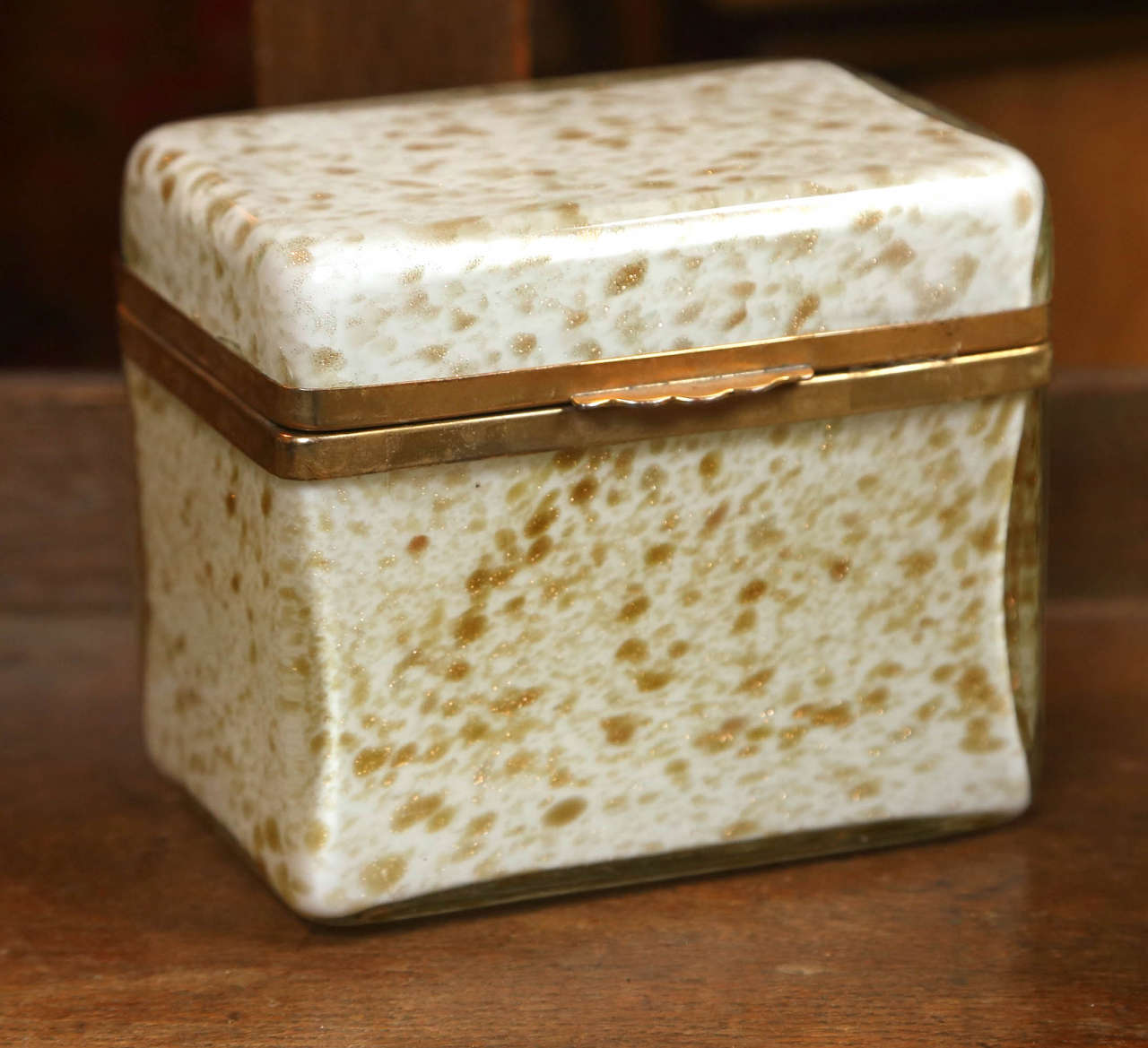 A vintage Murano glass box of white with gold flecks having bronze mounts.