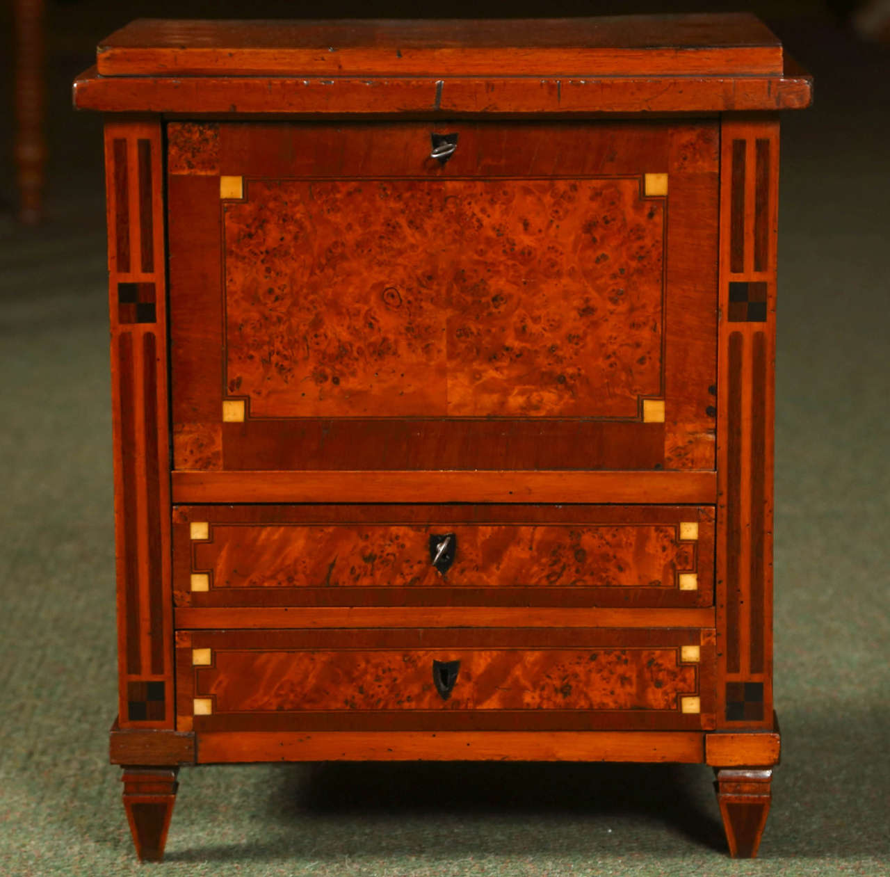A wonderful miniature secretaire abattant featuring mixed veneers including oyster burl, rosewood, mahogany, ebony and bone elements. (one of the rarest of all miniature furniture).