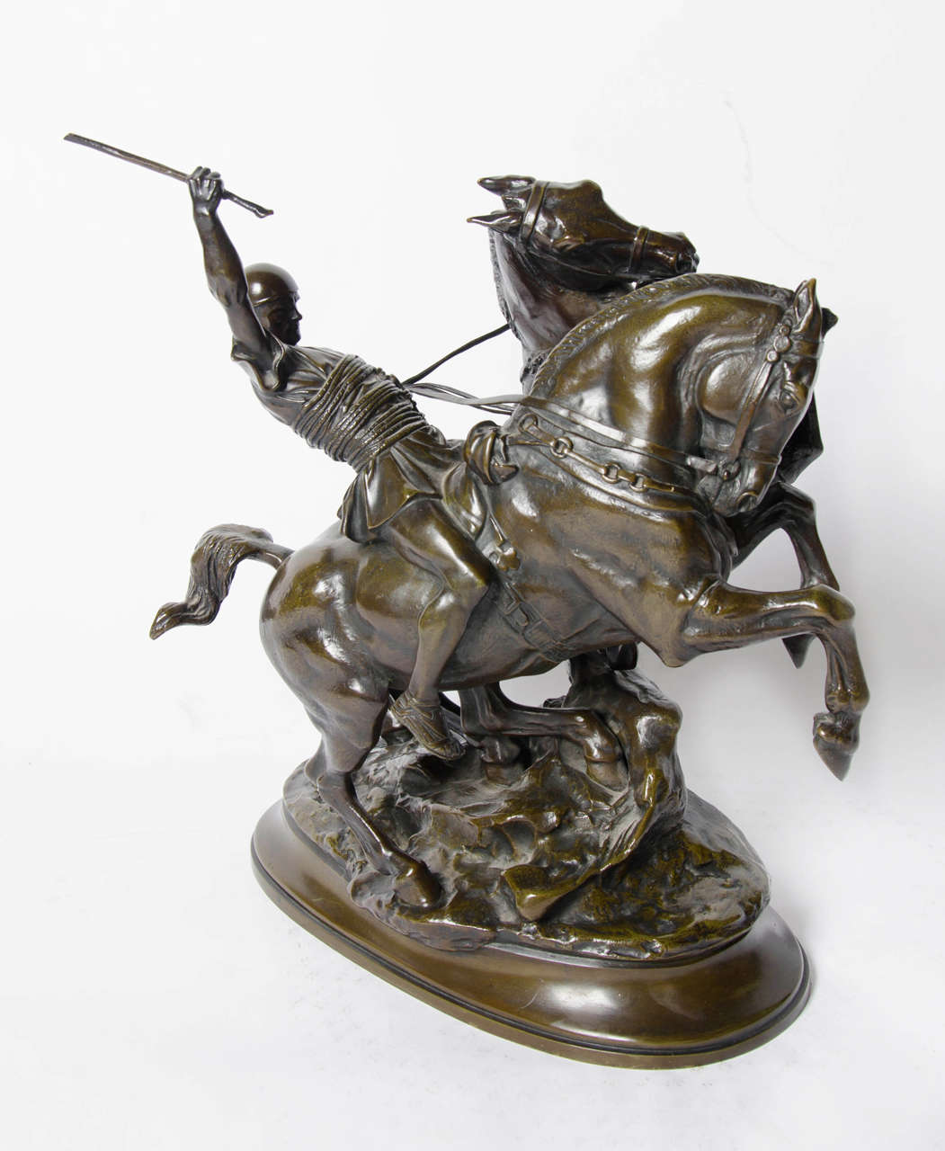 Cocher Romain by Emmanuel Fremiet (1824-1910), an impressive study of a Roman charioteer with two rearing horses. Brown green patination, stunning hand chased detail and characterization. Set onto a part naturalistic integral plinth with emblem