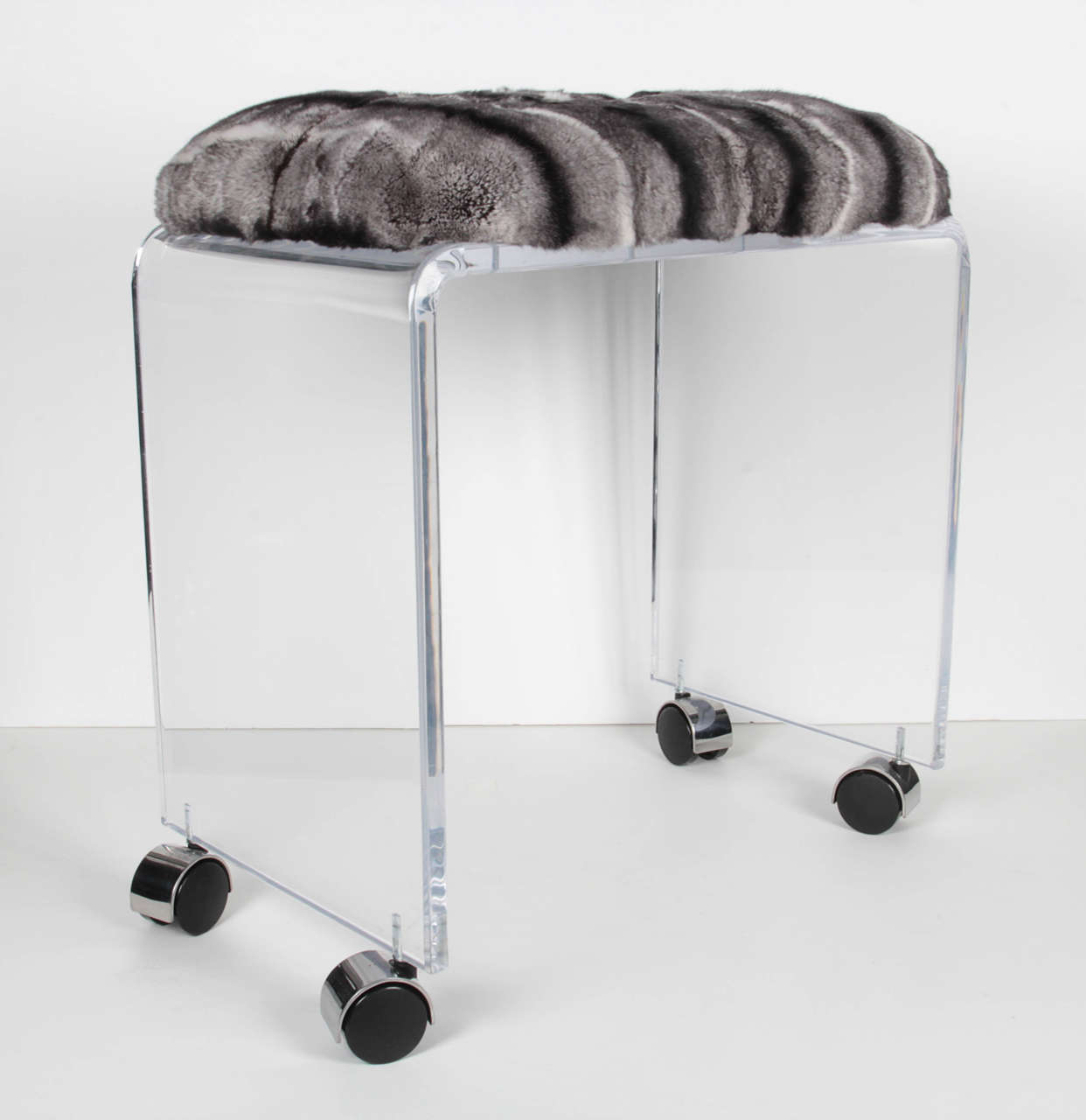 A lucite and rex rabbit stool on casters. Newly upholstered.