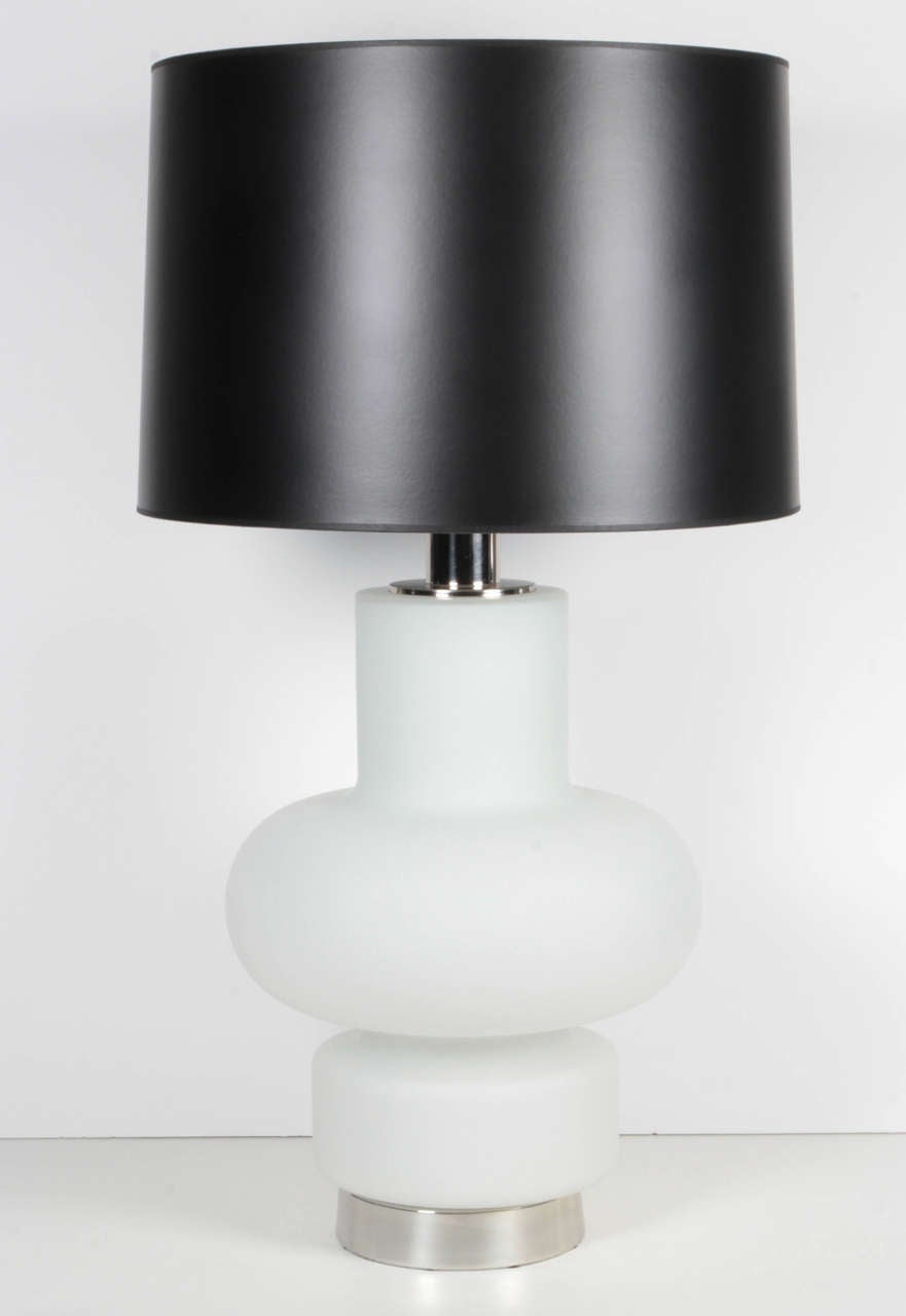 A great sculptural pair of white frosted glass lamps with black paper shades. The lamps can be lit up on the inside, out or both with a 3-way switch. The lamps sit of a polished chrome base.