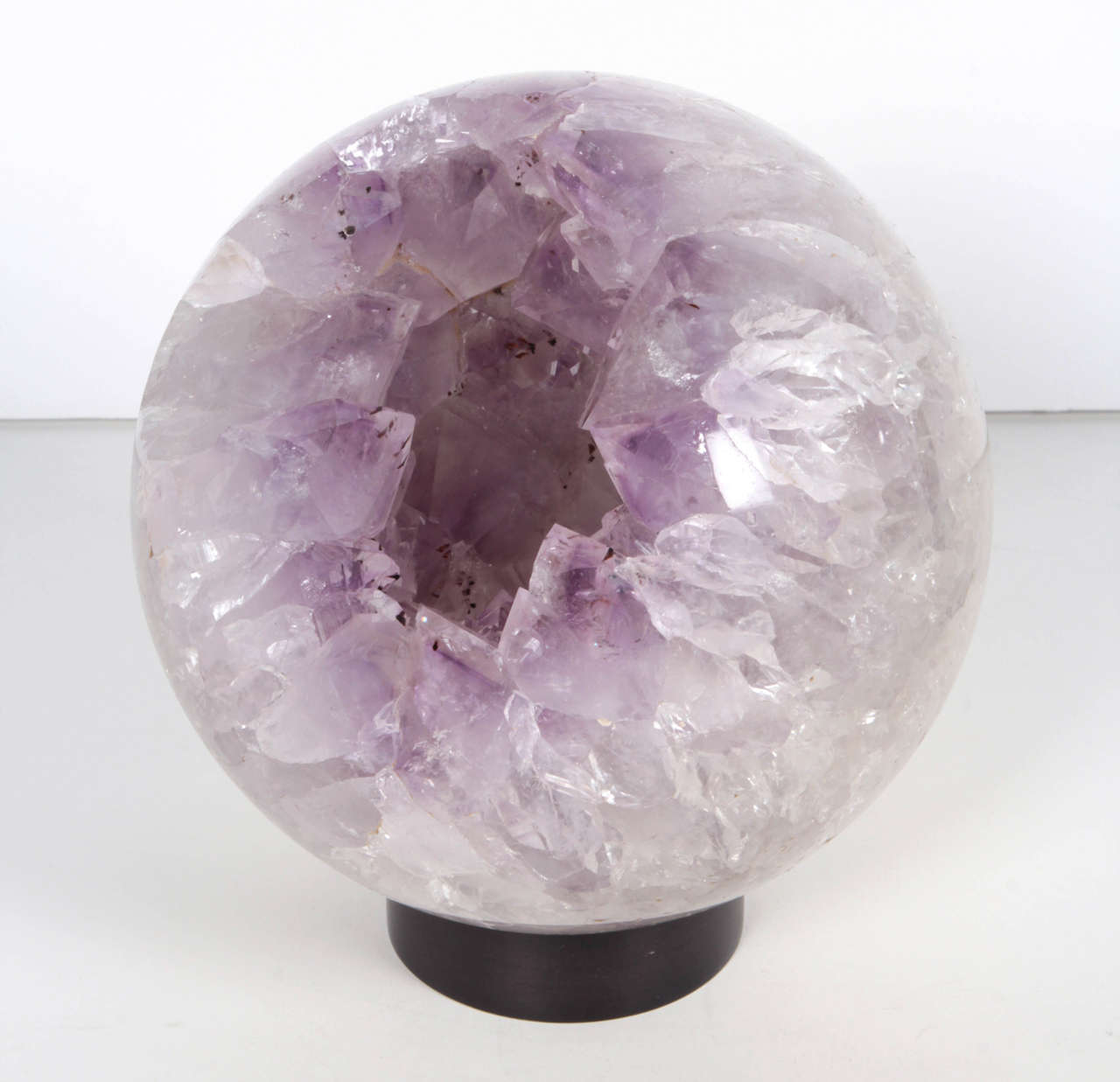 An amazing sculptural amethyst orb on metal stand.