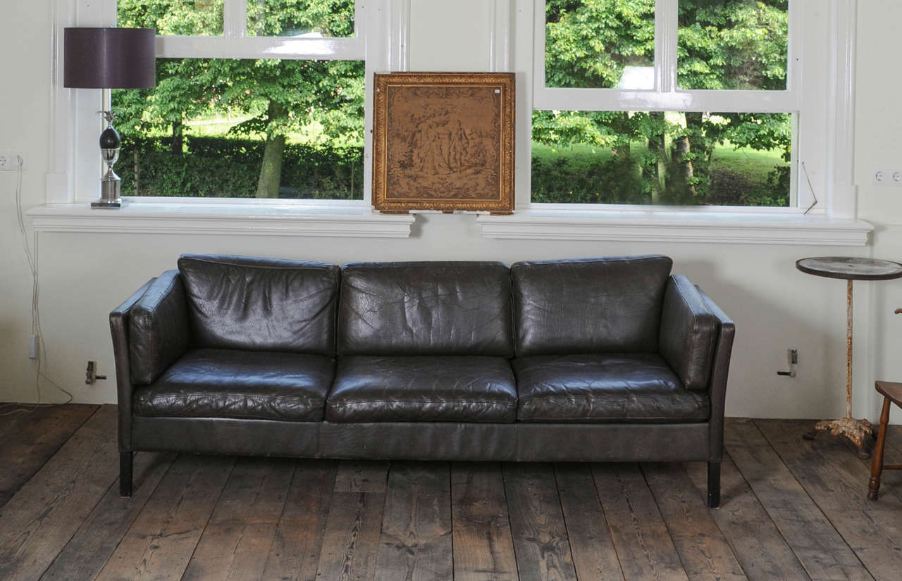 A 1960s Danish three-seat vintage design sofa with black leather upholstered, by Mogens Hansen.