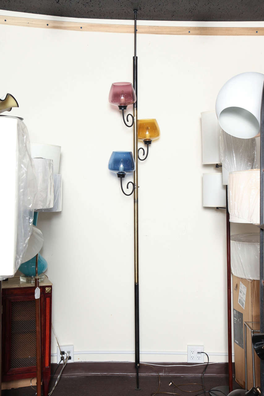 Unusual Murano pole lamp. Graceful scrolled arms. With Murano glass pastel shades. Enameled metal and brushed brass. Sculptural in design. Adjustable tension pole 99 inches tall. Arms are 7 inches span. Three 60 watt bulbs.
REDUCED from 1500.00 To