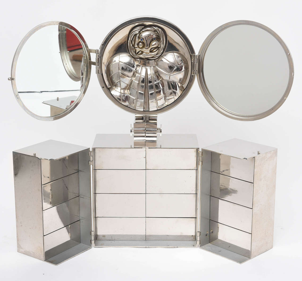 A rare design seldom seen in the market. The design folds from a minimal box into a fantastic combination of 16 felt lined drawers and hinged mirrors.
The sculpture is a homage to Paloma Picasso.
Less than 85 were produced.