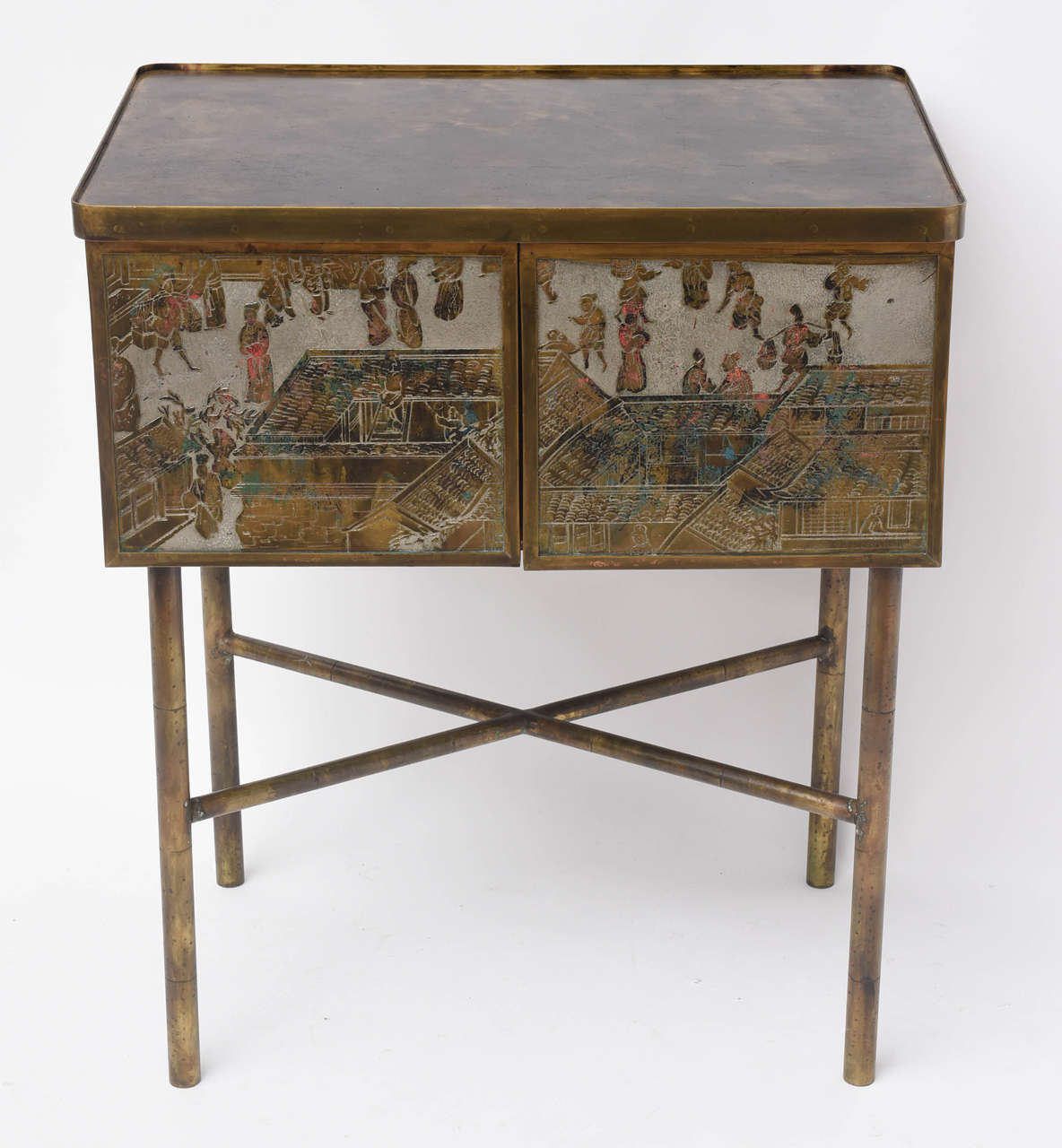A diminutive chinoiserie cabinet consisting of acid-etched and enameled panels of brass and pewter.
Original painted interior.