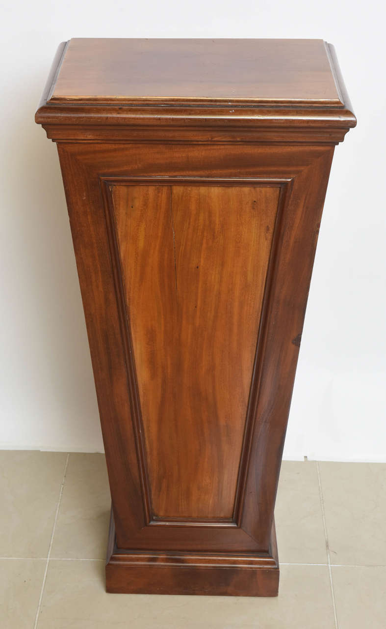 Of tapering form, with panels and moulded base and top-overall painted in faux bois.