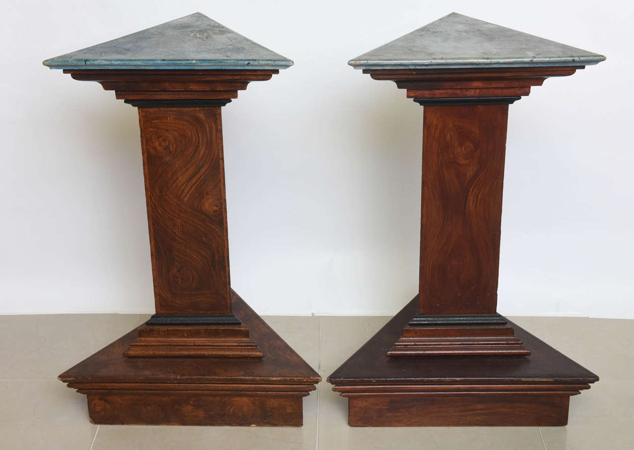 The triangular faux marble-top above a conforming column and stepped base painted in faux bois.