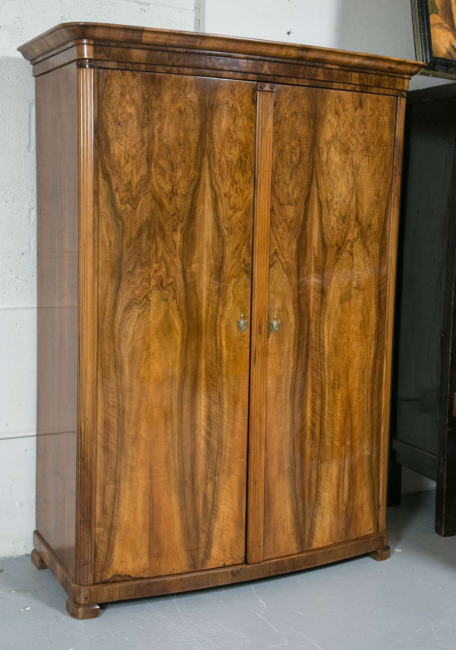 A very fine and rare 19th century Swedish Biedermeier ash-wood armoire chest featuring a bow-front, this large and impressive armoire chest has an upper bar to hang your clothes as well as a pair of lower drawers. All handcrafted and disassembles
