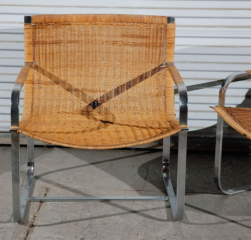 pair of wicker and chrome armchairs